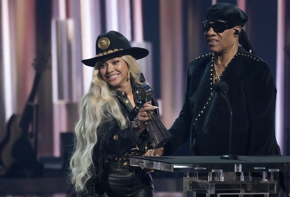 Beyonce, left, accepts the Innovator Award as presenter Stevie Wonder looks on during the iHeartRadio Music Awards, Monday, April 1, 2024, at the Dolby Theatre in Los Angeles. (AP Photo/Chris Pizzello ...