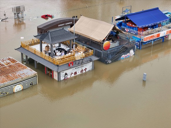 epa13093987 A riverside park is seen inundated by the surging flood brought by Typhoon Maysak in Nanning in southern China's Guangxi Zhuang Autonomous Region, 07 July 2026. The meteorological aut ...