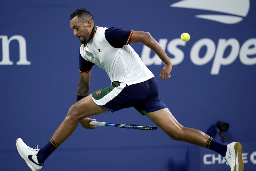 Nick Kyrgios, of Australia, returns a shot between his legs against Roberto Bautista Agut, of Spain, during the first round of the US Open tennis championships, Monday, Aug. 30, 2021, in New York. (AP ...