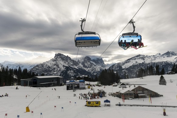 Eine Skifahrerin und 3 Snowboarder benutzen die soeben eingeweihten Sesselbahn Bidmi-Kaeserstatt bei Saisoneroeffnung des Skigebiets Haslital im Berner Oberland, am Samstag, 14. Dezember 2013 in Hasli ...