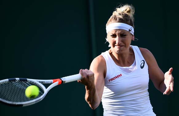 epa06066163 Timea Bacsinszky of Switzerland in action against Monica Puig of Puerto Rico during their first round match for the Wimbledon Championships at the All England Lawn Tennis Club, in London,  ...