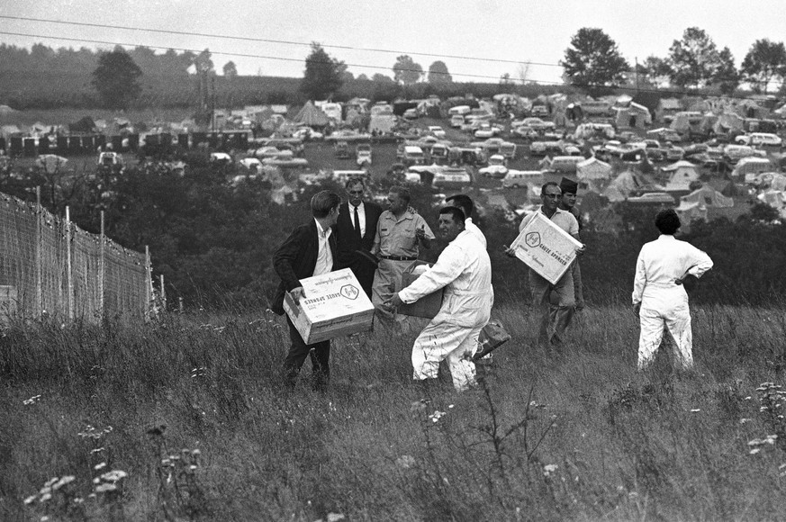 In this Aug. 17, 1969 file photo, workers carry medical supplies that arrived by helicopter on the grounds of the Woodstock Music and Art Festival in Bethel, N.Y. Helicopters were pressed into service ...