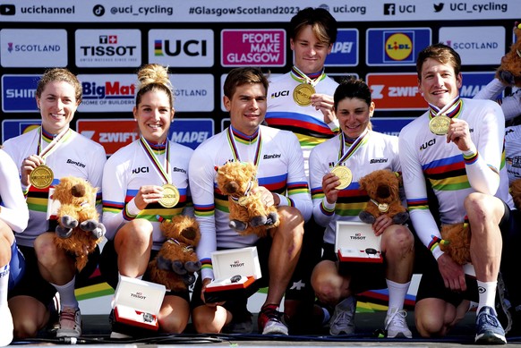 Switzerland&#039;s Stefan Bissegger, Stefan Kung, Mauro Schmid, Elise Chabbey, Nicole Koller and Marlen Reusser celebrate on the podium after winning gold in the Team Time Trial Mixed Relay race on da ...