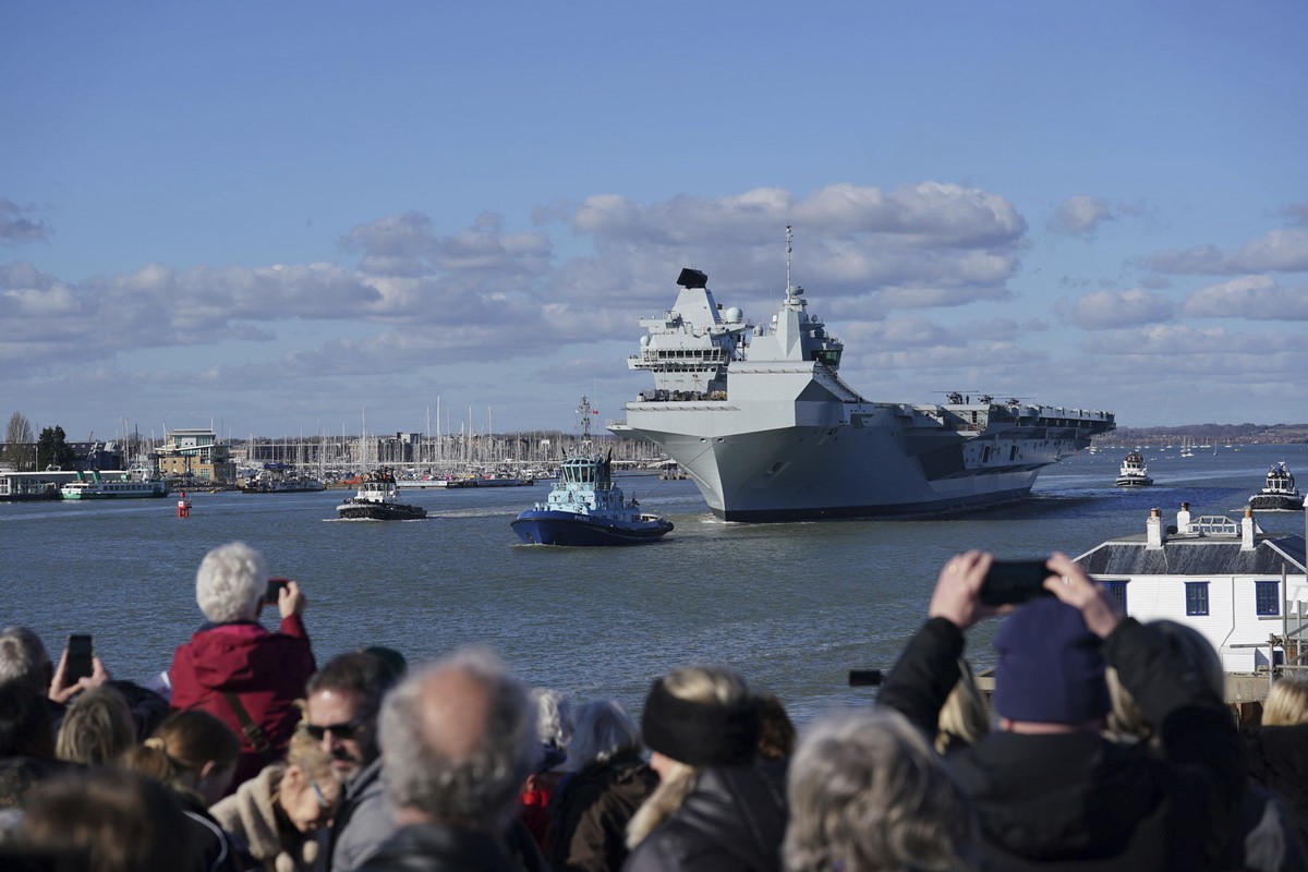 People watch as Royal Navy aircraft carrier HMS Prince of Wales sets sail from Portsmouth Harbour to lead the largest Nato exercise since the Cold War, involving more than 40 vessels, in Portsmouth, E ...