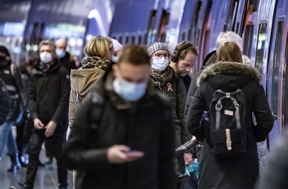 Passengers in a train station wear masks to curb the spread of coronavirus, in Malmo, Sweden, Thursday, Jan. 7, 2021. The Public Health Agency of Sweden advises passengers on public transport to wear  ...