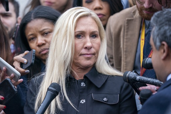 epa11236748 Republican Representative from Georgia Marjorie Taylor Greene (C) responds to questions from the news media following the House passage of the USD 1.2 trillion government funding package a ...