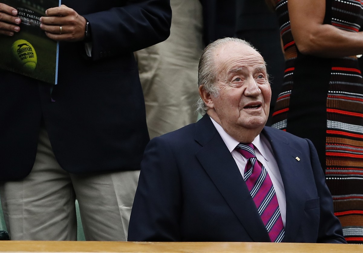 FILE - Former Spanish King Juan Carlos takes his seat for the Women's Singles final match between Venus Williams of the United States and Spain's Garbine Muguruza on day twelve at the Wimble ...