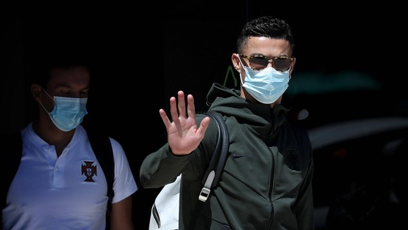 June 28, 2021, Lisbon, Portugal: Portugal s forward Cristiano Ronaldo waves as he arrives at Lisbon airport with teammates on June 28, 2021, after Portugal was eliminated by Belgium in the round of 16 ...