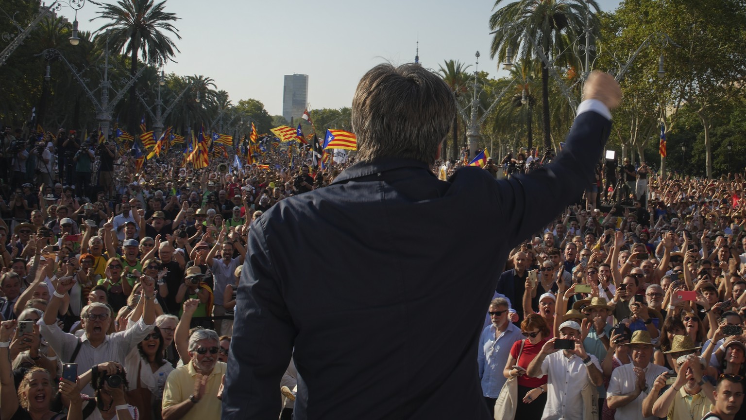 Catalan independence leader and former President Carles Puigdemont addresses supporters after his arrival near the Catalan parliament to allegedly attend the investiture debate in Barcelona, Spain, Th ...