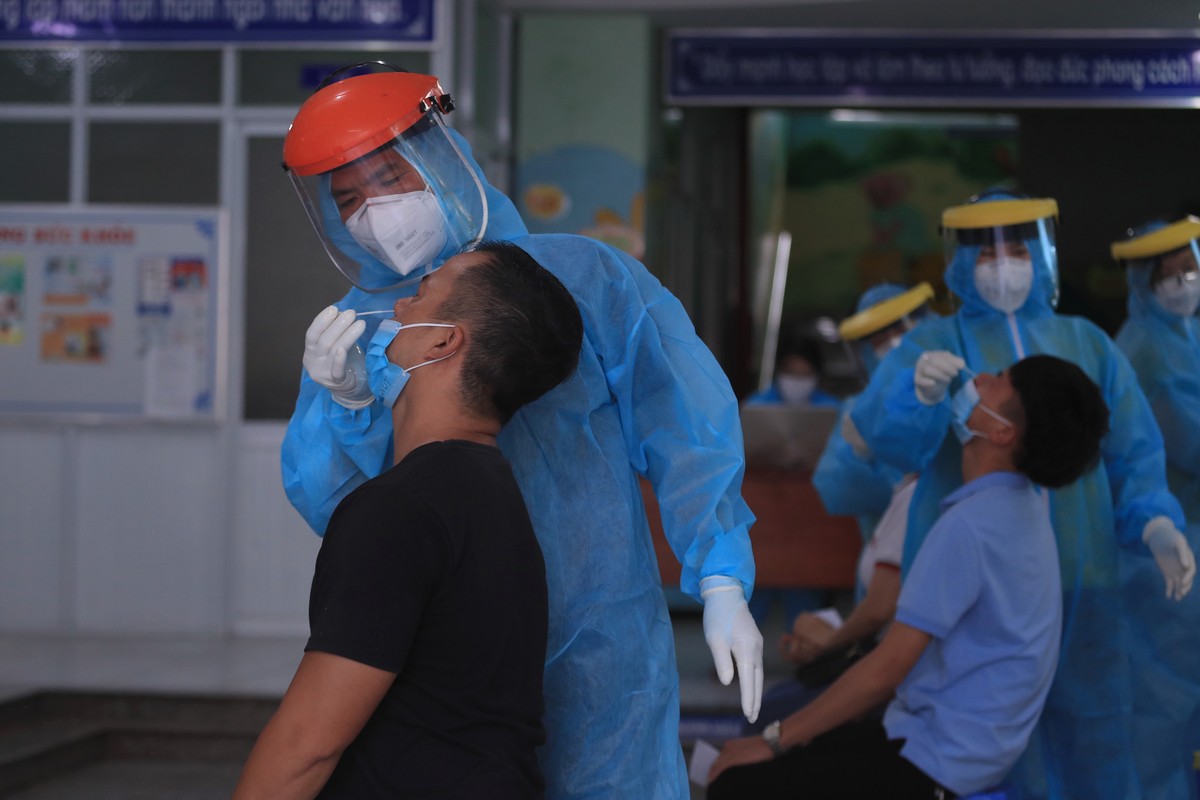 Medical workers take swab samples from people in Vung Tau city, Vietnam Saturday, Aug. 21, 2021. Vietnam's government said it is sending troops to Ho Chi Minh city to help deliver food and aid to ...