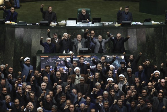 Iranian lawmakers chant anti-American and anti-Israeli slogans to protest against the U.S. killing of Iranian top general Qassem Soleimani, at the start of an open session of parliament in Tehran, Ira ...