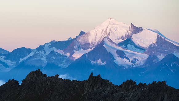 The Matterhorn mountain, left, and the Weisshorn moutain, right, after sunrise with the view out of Eggishorn moutain, in Fiesch, Switzerland, early Tuesday, July 28, 2015. (KEYSTONE/Dominic Steinmann ...