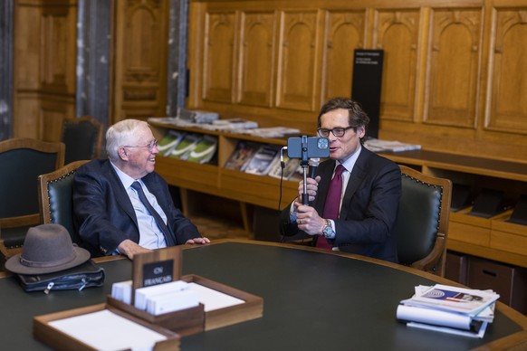 epa10568169 National Councillor Roger Koeppel, SVP-ZH, right, interviews former Federal Councillor Christoph Blocher, during the extraordinary session of the Federal Council, in the antechamber of the ...