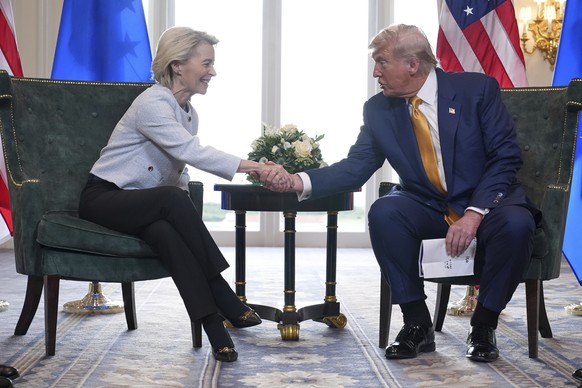President Donald Trump and European Commission President Ursula von der Leyen shake hands after reaching a trade deal at the Trump Turnberry golf course in Turnberry, Scotland Sunday, July 27, 2025. ( ...