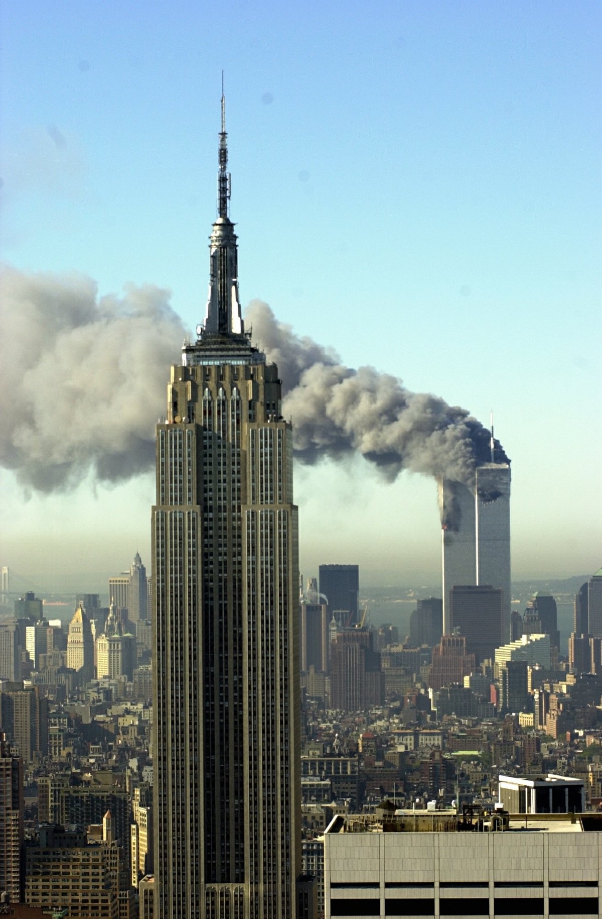 Plumes of smoke pour from the World Trade Center buildings in New York Tuesday, September 11, 2001. Planes crashed into the upper floors of both World Trade Center towers minutes apart Tuesday in a ho ...