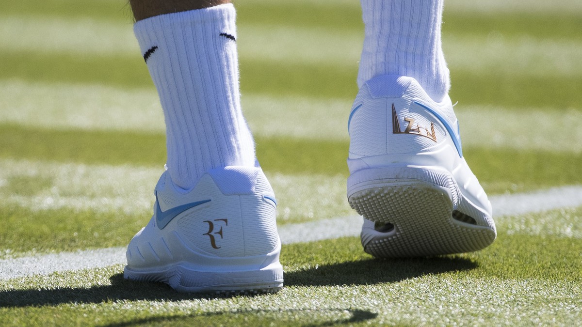 Roger Federer of Switzerland wears Nike shoes with his logo during a training session at the All England Lawn Tennis Championships in Wimbledon, London, Wednesday, June 27, 2018. The Wimbledon Tennis  ...