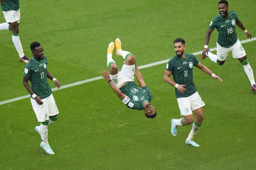 Saudi Arabia&#039;s Salem Al-Dawsari, second left, celebrates after scoring his side&#039;s second goal during the World Cup group C soccer match between Argentina and Saudi Arabia at the Lusail Stadi ...