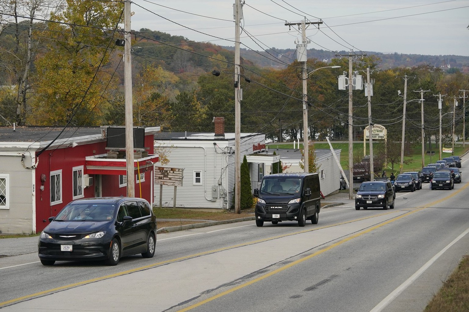 Three vehicles transport bodies from Schemengees Bar and Grille, Thursday, Oct. 26, 2023, in Lewiston, Maine. The restaurant was the site of one of the two mass shootings in Lewiston on Wednesday. (AP ...