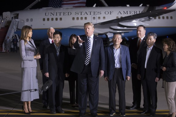 epa06724699 US President Donald J. Trump (C) delivers remarks to members of the news media after greeting three US detainees that were released by North Korea; Tony Kim (3-L), Kim Dong-Chul (4-R) and  ...