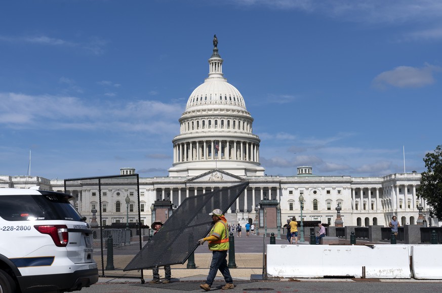 People walk to the U.S. Capitol as workers remove the fence surrounding the U.S. Capitol building, after six months was erected, following the Jan. 6 riot at the Capitol, on Saturday, July 10, 2021, i ...