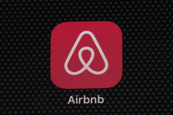 FILE - The Airbnb app icon is displayed on an iPad screen in Washington, D.C., on May 8, 2021. Airbnb says it?s banning the use of indoor security cameras in listings around the world by the end of ne ...