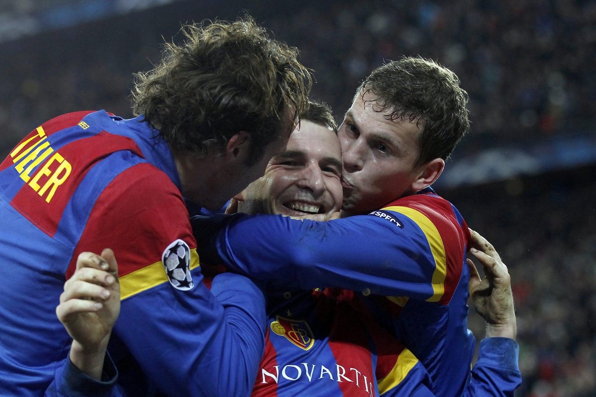 Basel's Alex Frei, center, celebrates after scoring the 2-0 with teammates Marco Streller, left, and Fabian Frei during the UEFA Champions League Group C soccer match between Switzerland's F ...