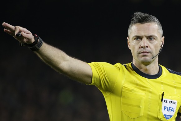 Referee Damir Skomina of Slovenia gestures during the Champions League round of sixteen second leg soccer match between FC Barcelona and Chelsea at the Camp Nou stadium in Barcelona, Spain, Wednesday, ...