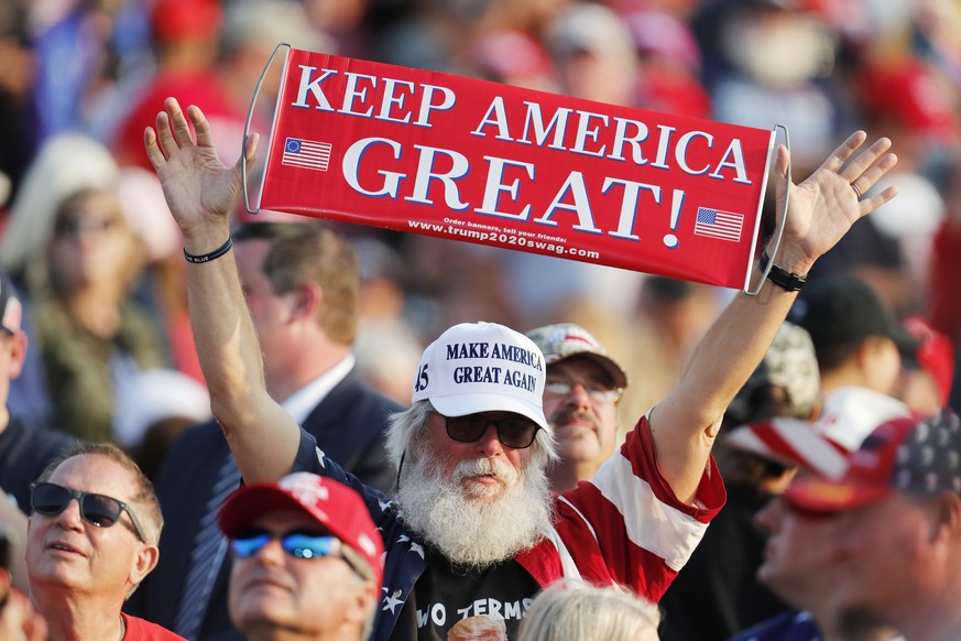 epa08689587 A supporter holds a banner prior to US President Donald J. Trump&#039;s &#039;Great American Comeback&#039; campaign event in Moon Township, Pennsylvania, USA, 22 September 2020. The Unite ...