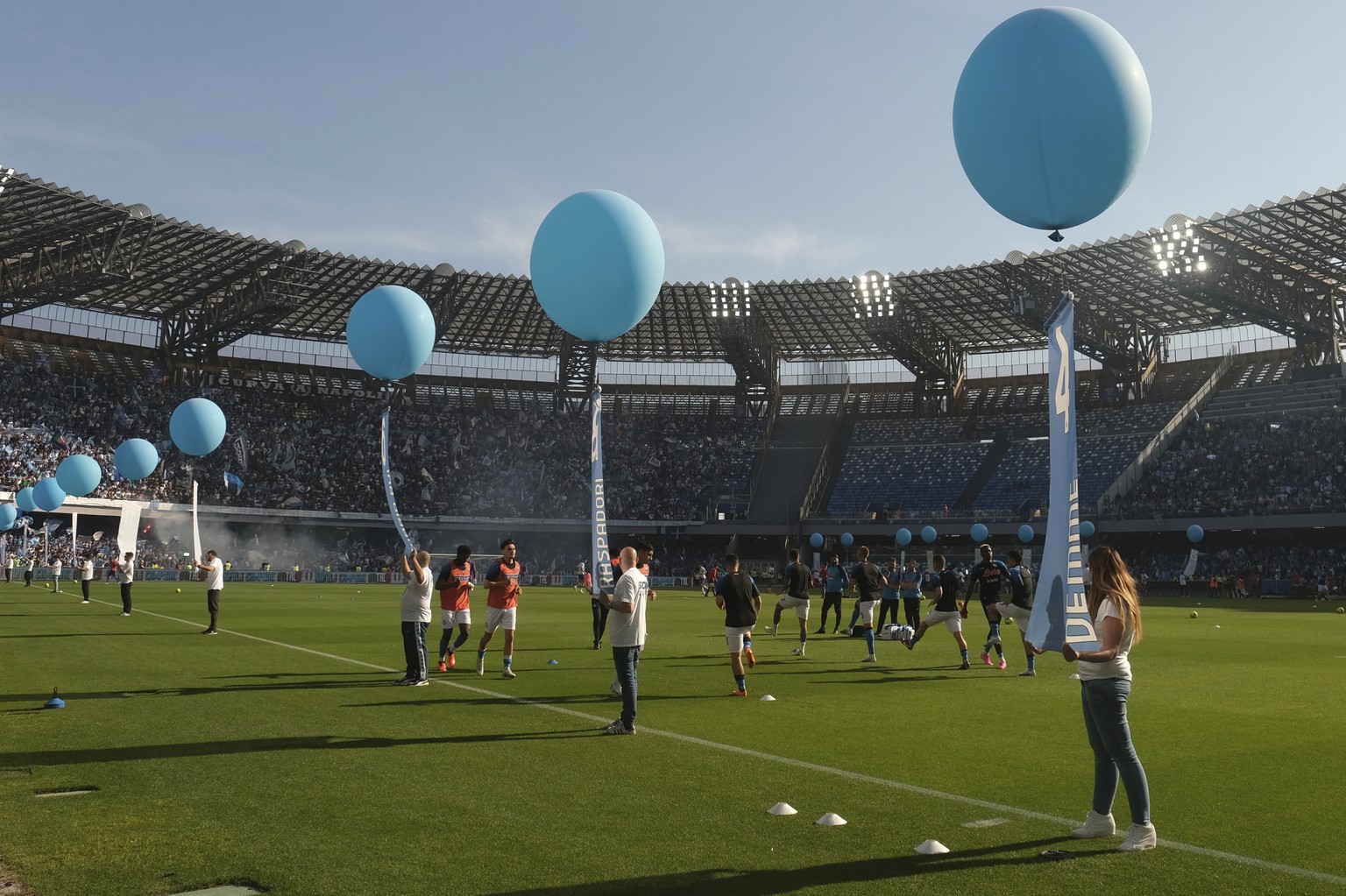 Balloons lift banners with numbers and names of Napoli players are held at the border of the field as Napoli fans still celebrate clinching, for the third time in the club&#039;s history, the &quot;sc ...