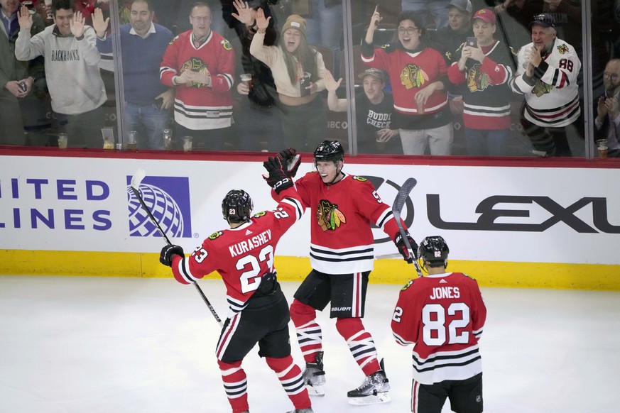 Chicago Blackhawks&#039; Connor Murphy, center, celebrates his goal with Philipp Kurashev (23) and Caleb Jones during the first period of an NHL hockey game against the Buffalo Sabres Tuesday, Jan. 17 ...