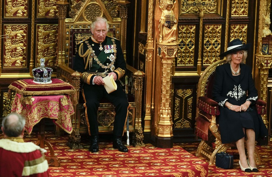 Prince Charles reads the Queen&#039;s speech as Camilla Duchess of Cornwall, listens, both seated next to the Queen&#039;s crown during the State Opening of Parliament, at the Palace of Westminster in ...
