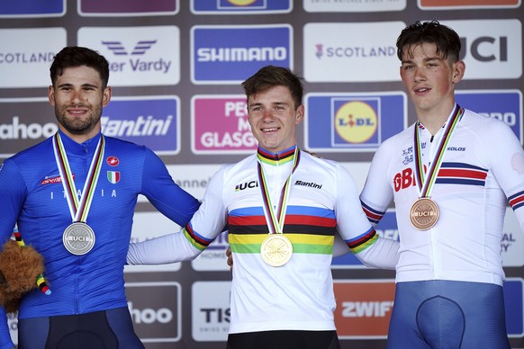 Belgium's Remco Evenepoel, centre, with the gold medal, Italy's Filippo Ganna, left, with the silver medal and Great Britain's Joshua Tarling with the bronze medal after the Men Elite I ...