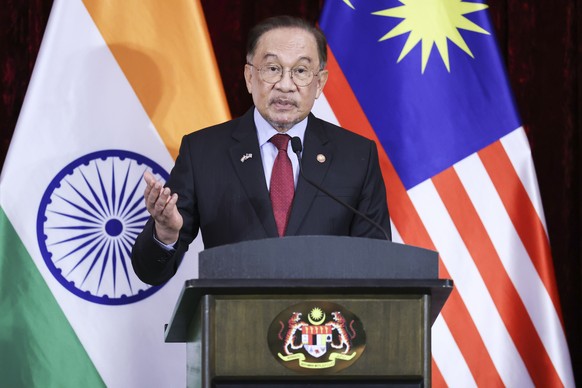 epa12714952 Malaysian Prime Minister Anwar Ibrahim speaks during a press conference with India's Prime Minister Narendra Modi (not pictured), on the second day of Modi's official visit, in P ...