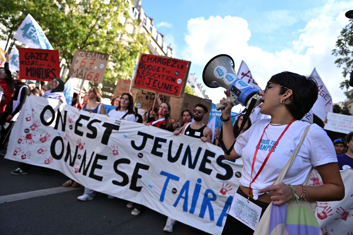 epa13300286 High school students and French Unions march behind a banner reading We are young, we will not remain silent during a national day of protest against education conditions in Paris, Franc ...
