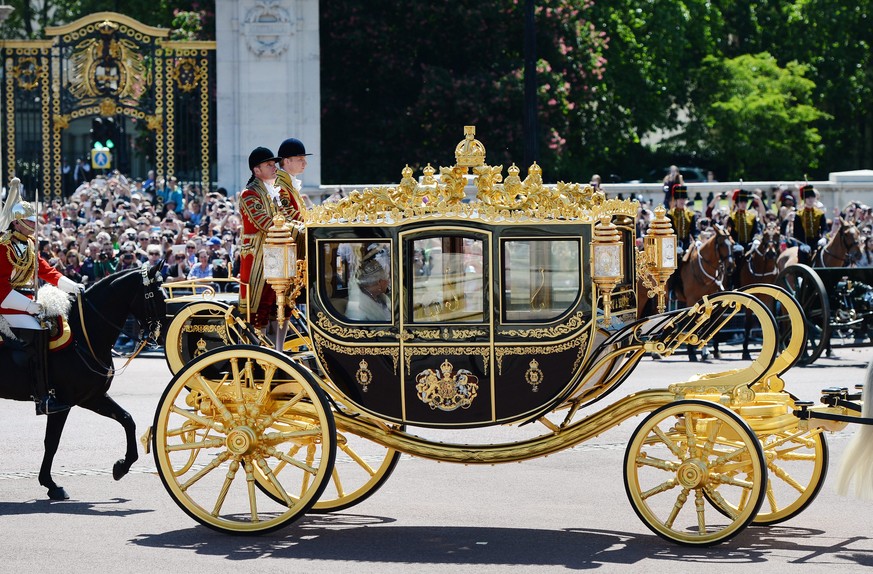 epa04769967 Britain&#039;s Queen Elizabeth II and the Prince Consort Prince Philip travel in a horse-drawn carriage from the Palace of Westminster to Buckingham Palace after the Queen&#039;s Speech, i ...