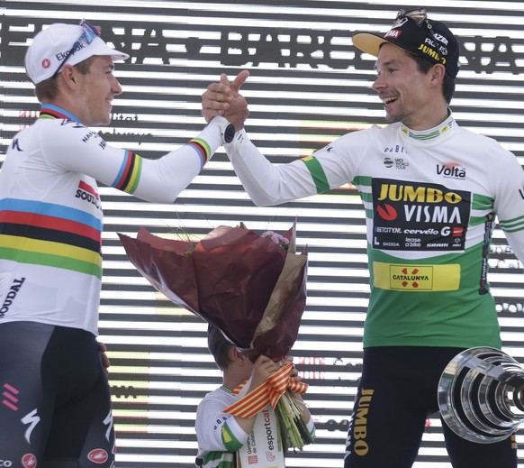 epa10544022 Second placed Belgian cyclist Remco Evenepoel (L) of Soudal Quick Step team and overall winner Slovenian Primoz Roglic of Jumbo-Visma team shakes hands on the podium after the seventh and  ...