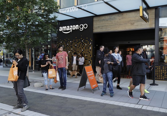 In this Monday, May 7, 2018, photo, pedestrians and cyclists gather near the Amazon Go store, in Seattle. Seattle&#039;s latest tax proposal to combat homelessness takes aim at large businesses such a ...