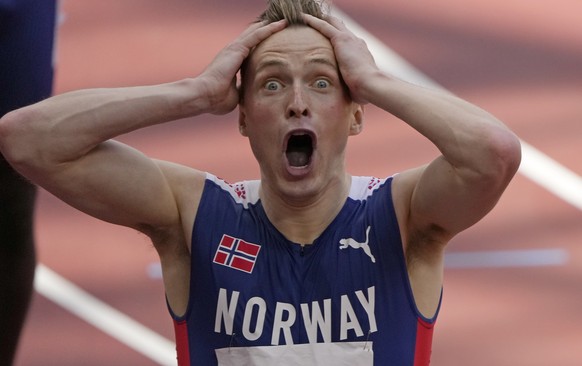 Karsten Warholm, of Norway celebrates as he wins the gold medal in the final of the men&#039;s 400-meter hurdles at the 2020 Summer Olympics, Tuesday, Aug. 3, 2021, in Tokyo, Japan. (AP Photo/Charlie  ...