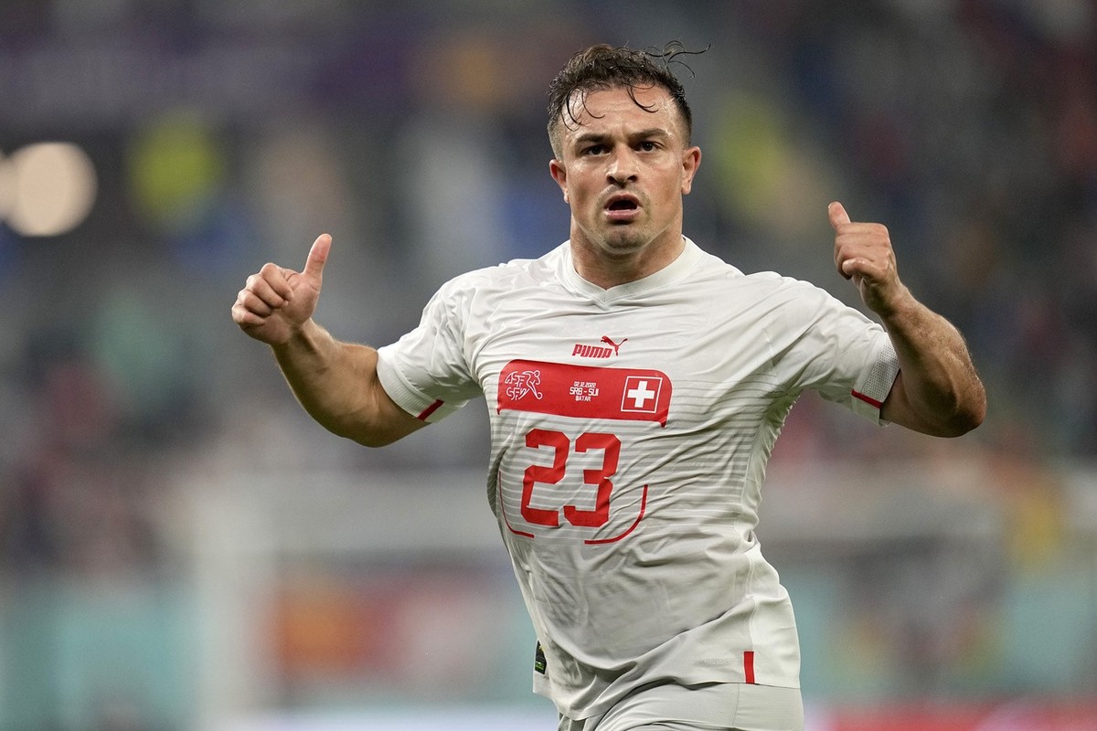 Switzerland's Xherdan Shaqiri celebrates after scoring his side's opening goal during the World Cup group G soccer match between Serbia and Switzerland, at the Stadium 974 in Doha, Qatar, Fr ...