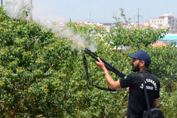 epa10623248 A police officer fires during clashes with supporters of Pakistan&#039;s former Prime Minister Imran Khan as Khan appears before Islamabad High Court in Islamabad, Pakistan, 12 May 2023. P ...