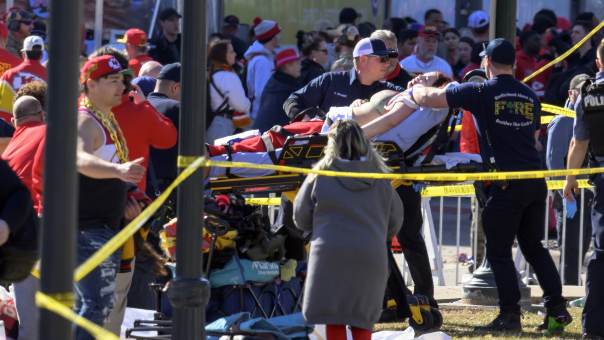 A woman is taken to an ambulance after an incident following the Kansa City Chiefs NFL football Super Bowl celebration in Kansas City, Mo., Wednesday, Feb. 14, 2024. The Chiefs defeated the San Franci ...