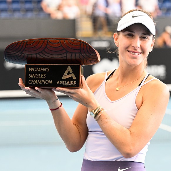 epa10404224 Belinda Bencic of Switzerland accepts the winners trophy after defeating Daria Kasatkina of Russia during the 2023 Adelaide International Tennis Tournament at the Memorial Drive Tennis Cen ...