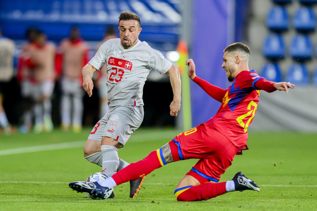 Switzerland's midfielder Xherdan Shaqiri, left, fights for the ball with Andorra's defender Albert Alavedra, right, during the UEFA Euro 2024 qualifying group I soccer match between Andorra  ...