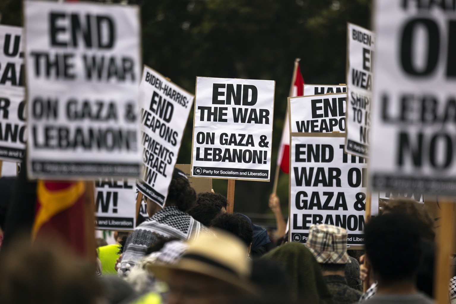 A protester waves a Lebanese flag as demonstrators gather to protest the war in Gaza and Lebanon in front of the Los Angeles Federal Building on Tuesday, Sept. 24, 2024, in Los Angeles. (AP Photo/Etie ...