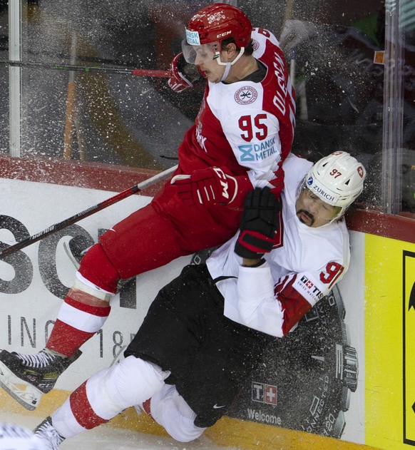 Denmark&#039;s forward Nick Olesen, left, checks Switzerland&#039;s defender Jonas Siegenthaler, right, during the IIHF 2021 World Championship preliminary round game between Denmark and Switzerland,  ...