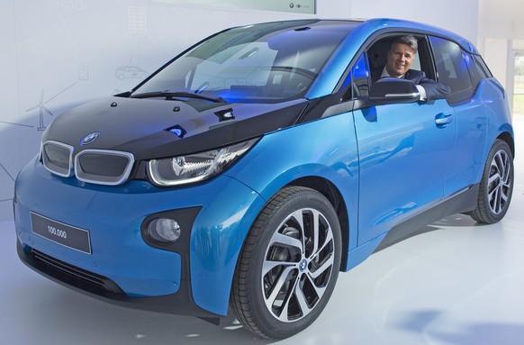 Harald Krueger, CEO of car manufacturer BMW, sits in a BMW i3 car after after it left the assembly line during the production anniversary of the 100,000th electric car at the plant of German luxury au ...