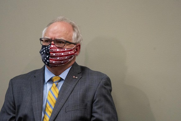 Gov. Tim Walz sits with a mask on during a news conference at the Department of Public Safety in St. Paul, Minn. on Saturday, May 23, 2020. Minnesota health officials are reporting a record high for C ...