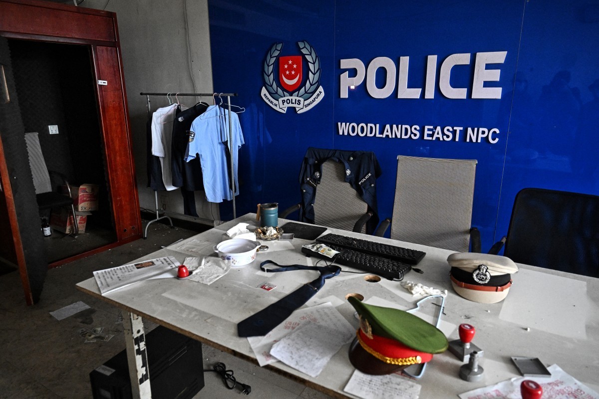 A room imitating a Singaporean police station is seen inside an abandoned scam centre in O'Smach town on the Thai-Cambodian border on March 12, 2026, during a press trip organised by Thailand ...
