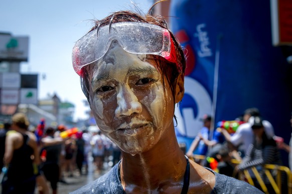 epa05905797 A Thai man with his face covered in white powder poses for a photo during the annual Songkran celebration at a touristic area in Bangkok, Thailand, 13 April 2017. The three-day annual Song ...