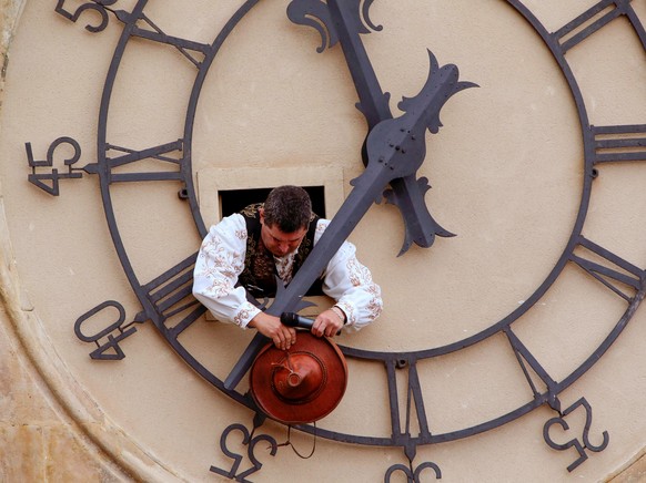 epa09555723 Angel Rufino de Haro, the so-called &#039;Mariquelo&#039;, observes the tradition of climbing up the New Cathedral&#039;s bell tower in Salamanca, Spain, 31 October 2021, to ring the bells ...